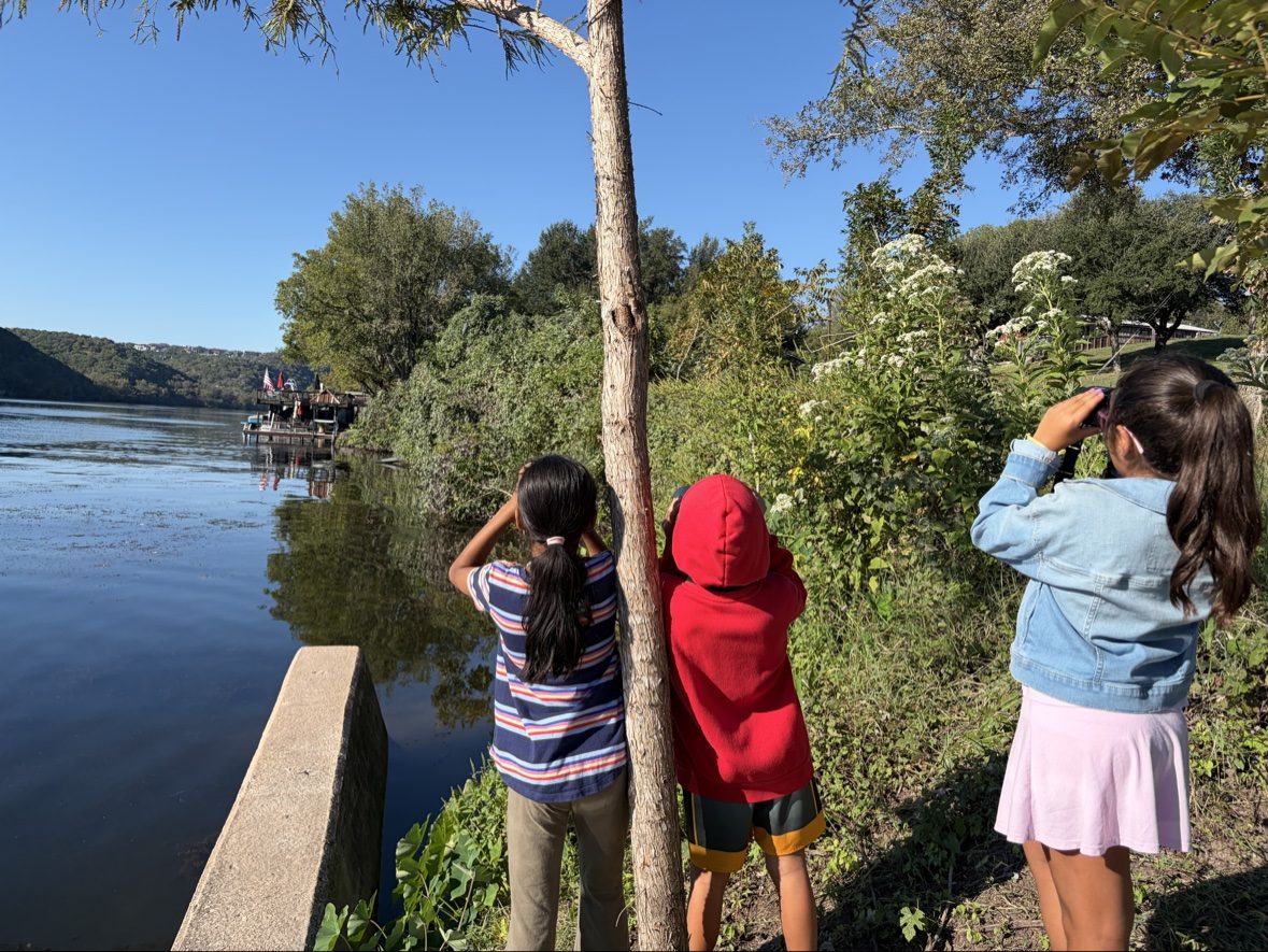 Campers with binoculars at the lake