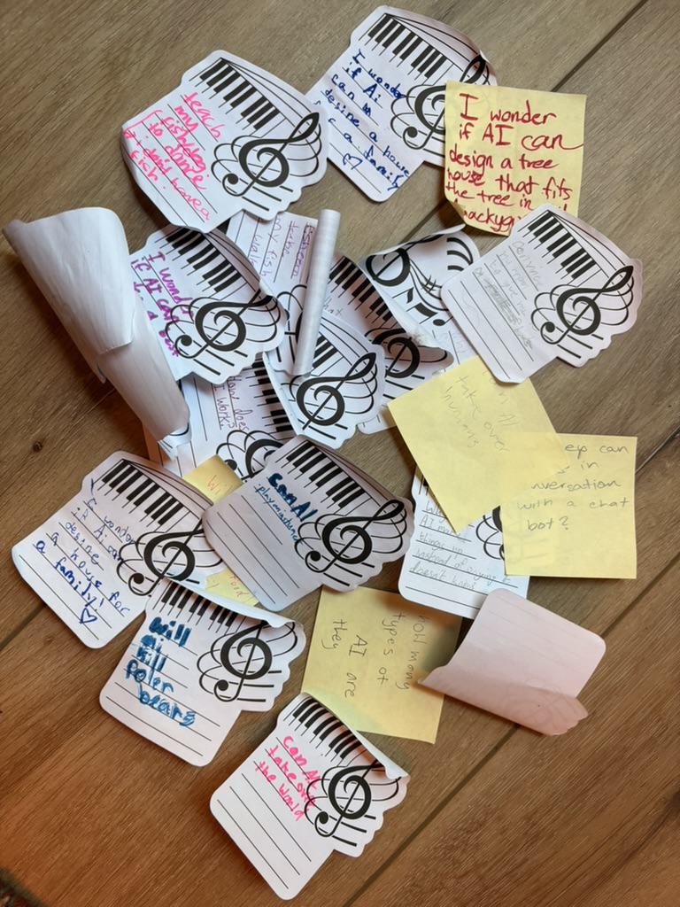 Handwritten 'I Wonder If AI Can' notes on music-themed cards and sticky notes